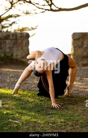 Teenage Female Dance Doing Backbend in the Park Stock Photo