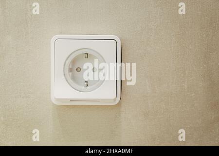 Power socket on the empty marble wall Stock Photo