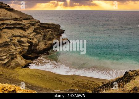 View of Papakolea the green sand beach on the big island at sunset. Stock Photo