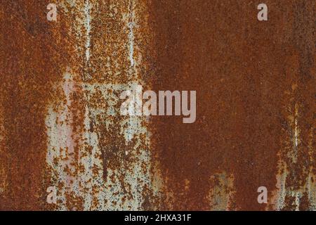 Macro fragment of the dark worn rusty metal wall texture, grunge background. Stock Photo