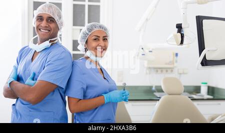 Two professional dentists standing in modern dental clinic Stock Photo