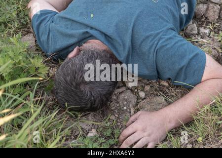 a dead man was found near the river, a dead man was drowned in a pond lake swamp. Stock Photo