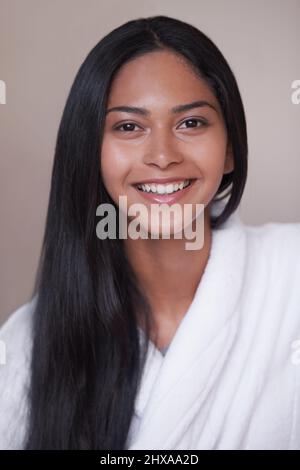 Shes excited for her day of pampering. Studio shot of a beautiful young woman in a bathroom. Stock Photo