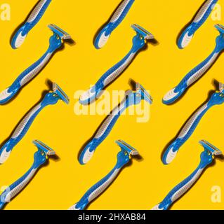 pattern with disposable shaving razors on yellow background Stock Photo