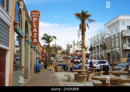Pismo Beach, California, USA - March 3, 2022. Pismo Beach Pier plaza. Shops, restaurants, walking people, downtown of city, city life Stock Photo