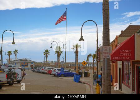 Pismo Beach, California, USA - March 3, 2022. Pismo Beach Pier plaza. Shops, restaurants, walking people, downtown of city, city life Stock Photo