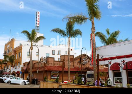 Pismo Beach, California, USA - March 3, 2022. Pismo Beach Pier plaza. Shops, restaurants, walking people, downtown of city, city life Stock Photo