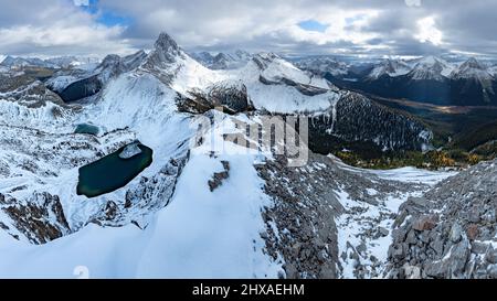 Large panorama of moutain s in Kananaskis , with a center view of Mt Birdwood in the late autumn with snow and Larch trees in the valley below. Stock Photo