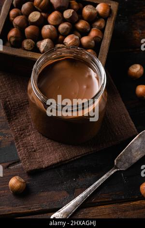 Sweet hazelnut spread set, on old dark wooden table background Stock Photo