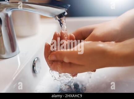 Keeping hands clean. Closeup shot of a hands being washed at a tap. Stock Photo