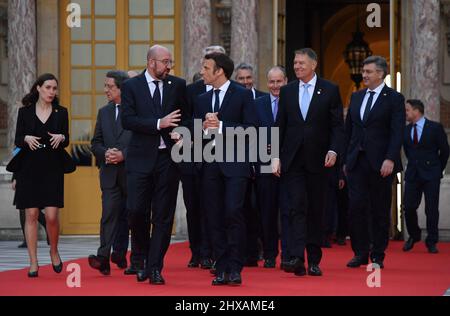 Versailles, France. 10th Mar, 2022. France's President Emmanuel Macron (3rd R) speaks to President of the European Council Charles Michel, followed by EU leaders at the Palace of Versailles, near Paris, on March 10, 2022, prior to the EU leaders summit to discuss the fallout of Russia's invasion in Ukraine. EU leaders are scrambling to find ways to urgently address the fallout of Russia's invasion of Ukraine that has imperilled the bloc's economy and exposed a dire need for a stronger defence..Photo by Christian Liewig/ABACAPRESS.COM Credit: Abaca Press/Alamy Live News Stock Photo