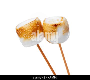 Grilled marshmallows on sticks isolated on white Stock Photo