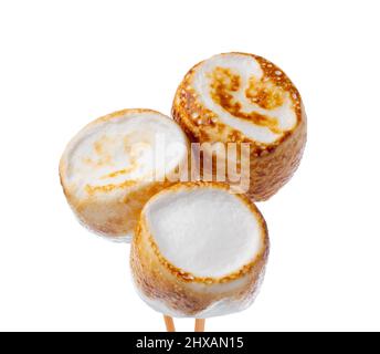 Grilled marshmallows on sticks isolated on white Stock Photo