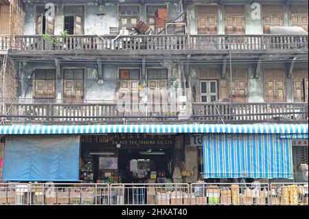 Row of old houses in Bangkok Chinatown with shop selling traditional Chinese delicacies and dried foodstuffs Stock Photo