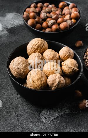 Whole organic walnuts set, on black dark stone table background Stock Photo