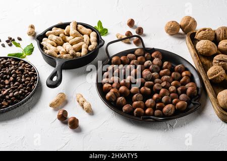 Mix of different nuts, peanut, walnut, pine nuts and hazelnut set, on white stone table background Stock Photo