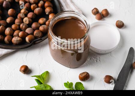 Chocolate Hazelnut Spread set, on white stone table background Stock Photo