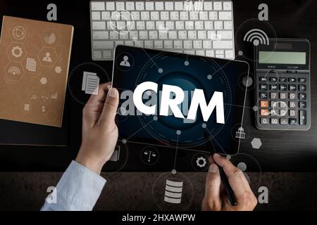 CRM Business Customer CRM Management Analysis Service Concept Business team hands at work with financial reports and a laptop Stock Photo