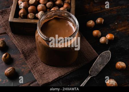 Chocolate Hazelnut Spread set, on old dark wooden table background Stock Photo