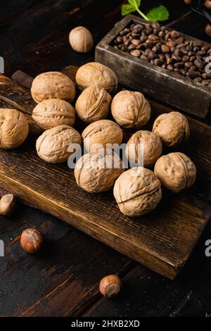 Whole organic walnuts set, on old dark wooden table background Stock Photo