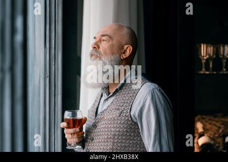 close-up. portrait of a handsome man with a glass of red wine . Stock Photo