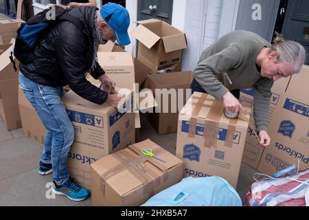 As the war in Ukraine enters its third week, volunteers based at the Ukrainian restaurant 'Prosperity' in Twickenham, handle a mass of donations brought by locals, destined for Ukrainian refugees who have reached Poland, on 10th March 2022, in London, England. Volunteers are working 12-hour days here trying to keep up with thousand of items eg. clothing, sleeping bags, toys, womens' sanitary products, rucksacks, elctrical chargers, nappies and basic medicines for those who have escaped the Russian invasion. Stock Photo