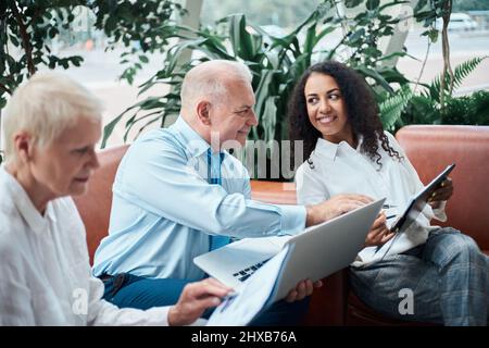 businessman discussing financial statistics with his assistants . Stock Photo