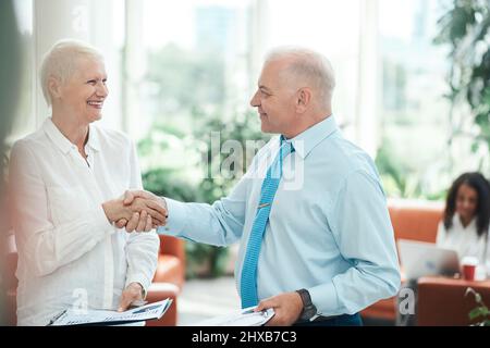 smiling financial partners shaking hands . close up. Stock Photo