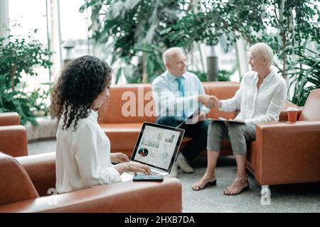 business woman using a laptop to analyze financial data. Stock Photo