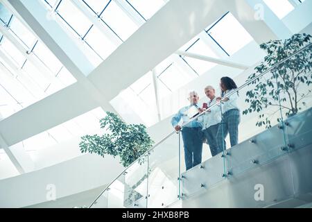 group of business people standing on the balcony of a business center. Stock Photo