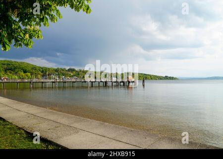 a long wooden pier in Herrsching on Lake Ammersee in Bavaria (Germany) Stock Photo