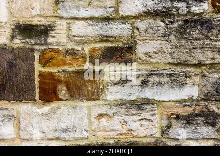 Old stone and bricks on a church building closeup abstract background. Stock Photo