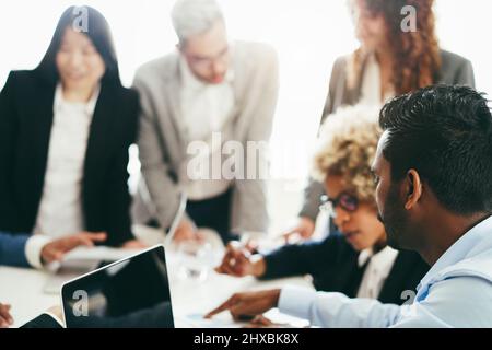 Business young people working inside company office - Startup and smart projects concept - Focus on indian man ear Stock Photo