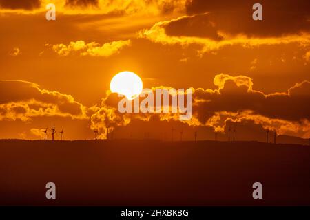 Sunset over wind turbines in the Vale of Clwyd, North Wales Stock Photo