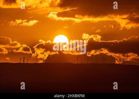 Sunset over wind turbines in the Vale of Clwyd, North Wales Stock Photo