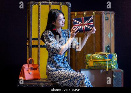 London, UK. 11 March 2022. A staff member presents a Chanel Union
