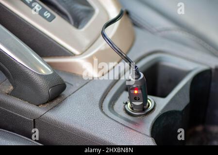 Red light on a 12V plug in an automotive cigarette lighter Stock Photo