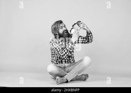 making mix. hipster man drink coffee. handsome bearded man holding a white cup. mug with beverage. drinking tea or coffee. good morning. morning vibes Stock Photo