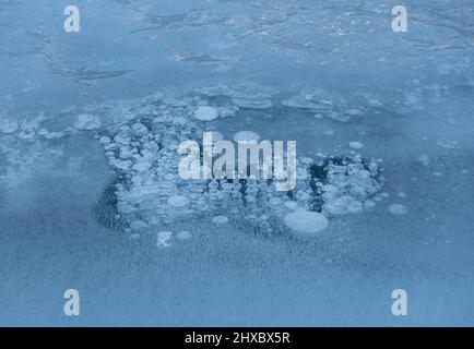 Bubbles of air trapped in frozen ice Stock Photo
