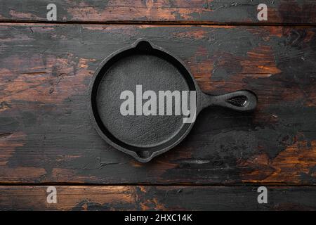Used old empty frying pan with copy space for text or food with copy space for text or food, top view flat lay , on old dark wooden table background Stock Photo