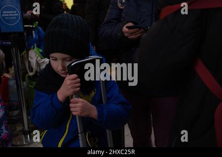 Przemysl, Poland. 08th Mar, 2022. A Ukrainian boy clutches a suitcase at Przemysl station. (Photo by Fer Capdepon Arroyo/Pacific Press) Credit: Pacific Press Media Production Corp./Alamy Live News Stock Photo