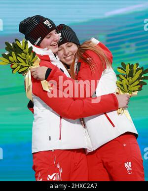 Barbara Aigner of Austria and guide Klara Sykora celebrate after