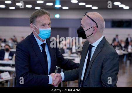 Bonn, Germany. 11th Mar, 2022. Hans-Joachim Watzke (l), DFB Vice President, congratulates Bernd Neuendorf on his election as the new president of the German Football Association. The 60-year-old prevailed over candidate Peters in the election held during the DFB's national convention in Bonn on Friday. Credit: Ronald Wittek/EPA-Pool/dpa/Alamy Live News Stock Photo