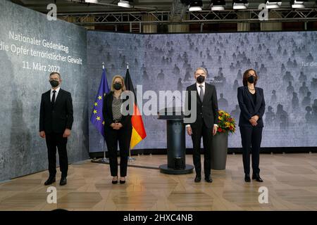 11 March 2022, Berlin: Pascal Kober (l-r), Federal Government Commissioner for the Concerns of Victims of Terrorist and Extremist Attacks in Germany, Nancy Faeser (SPD), Federal Minister of the Interior and Home Affairs, Stephan Harbarth, President of the Federal Constitutional Court, and Petra Terhoeven, historian, stand during the national anthem at the German government's commemoration of the victims of terrorist violence. The Day of Remembrance, which is to be held annually on March 11, ties in at the national level with the European Day of Remembrance, which was established after the Madr Stock Photo