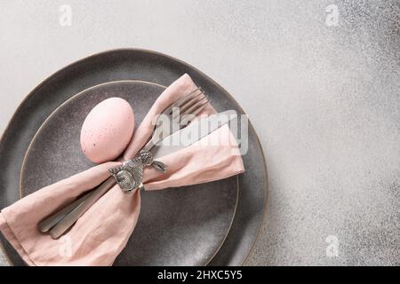 Easter dinner with pink egg, elegance table setting. Top view. Copy space. Stock Photo