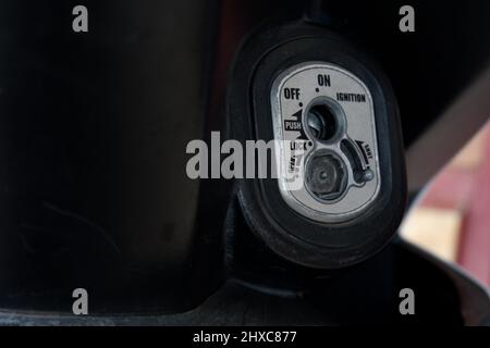 Close up motorcycle keyhole for ignition and lock in the open state then starting the engine Stock Photo