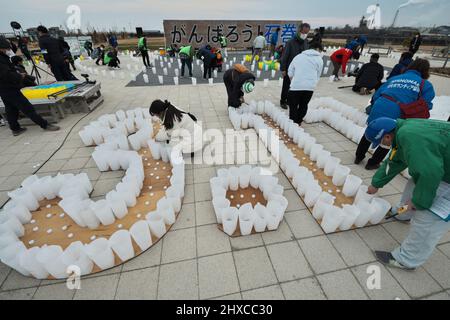 Ishinomaki, Japan. 11th Mar, 2022. People light paper lanterns at Ishinomaki Minamihama Tsunami Recovery Memorial Park, Ishinomaki, Miyagi-prefecture, Japan on Friday, March 11, 2022. Photo by Keizo Mori/UPI Credit: UPI/Alamy Live News Stock Photo