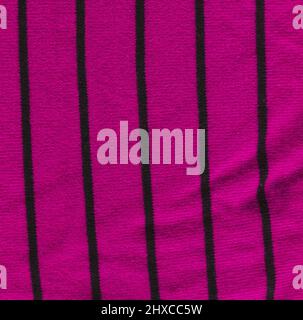 Knitted textured purple fabric background. Beautiful violet fabric texture with black stripes. Stock Photo