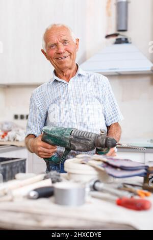 Man working with drill Stock Photo