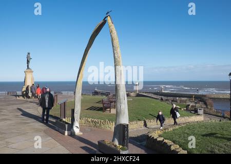 Captain Cook Statue,and,Whalebone Arch,whale,bones,from,Bowhead Whale,with,views,along,Esplanade Crescent,West Cliff,coast,coastline,seafront,headland,of,this,popular,tourist,attraction,seaside,beach,resort,of,Whitby,Borough of Scarborough,near,Scarborough,  North,North Yorkshire,Yorkshire,England,English,UK,United Kingdom,GB,Great Brtiain,British,Europe,Whitby,Yorkshire,England,English,UK,United Kingdom,GB,Great Brtiain,British,Europe, Stock Photo